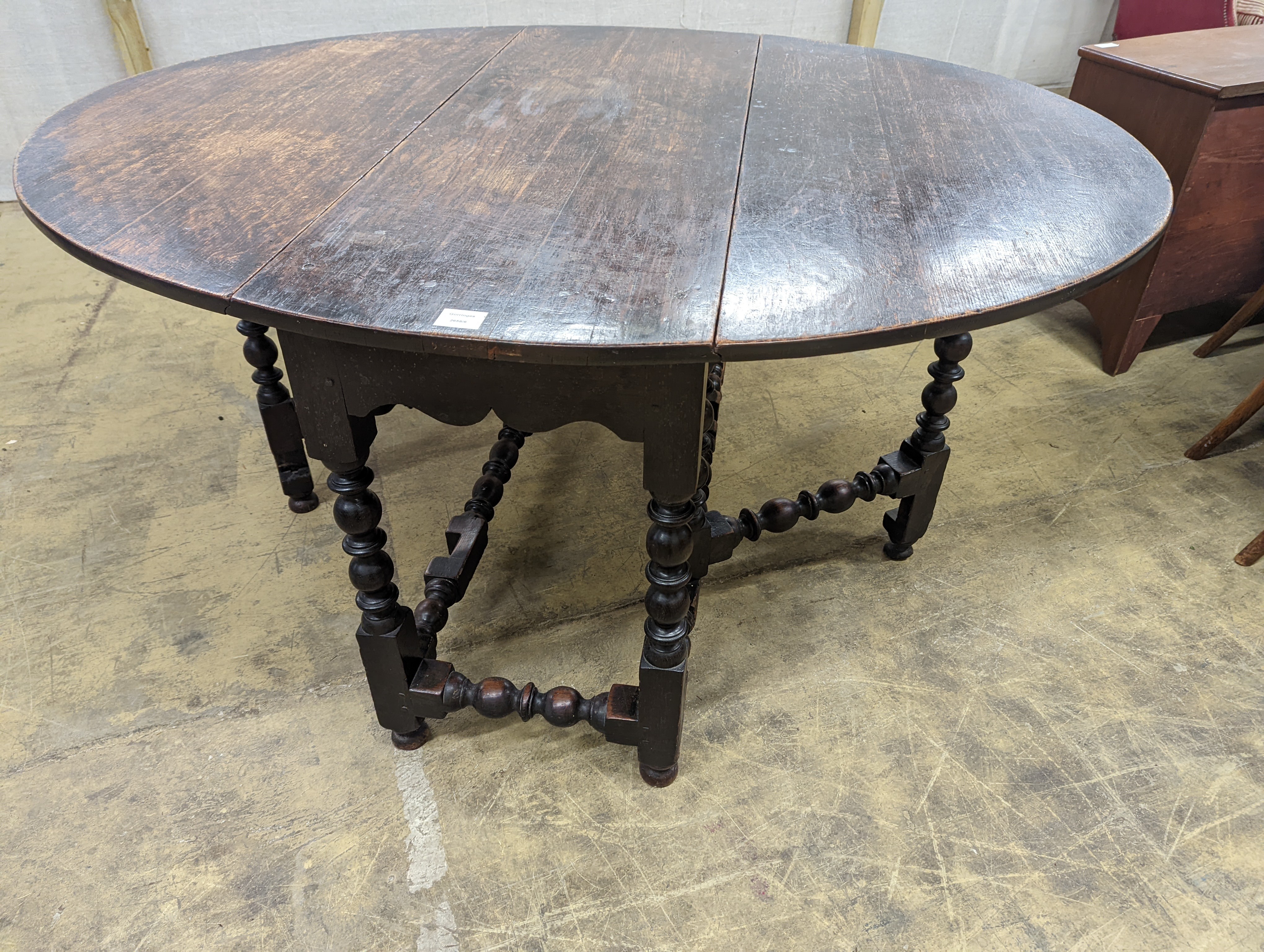 An 18th century oak gateleg table, length 146cm extended, depth 119cm, height 74cm